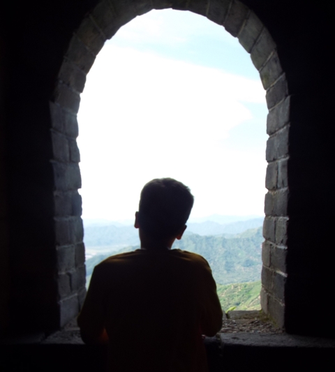 Andrew's silhouette in the dark, cool bell tower.