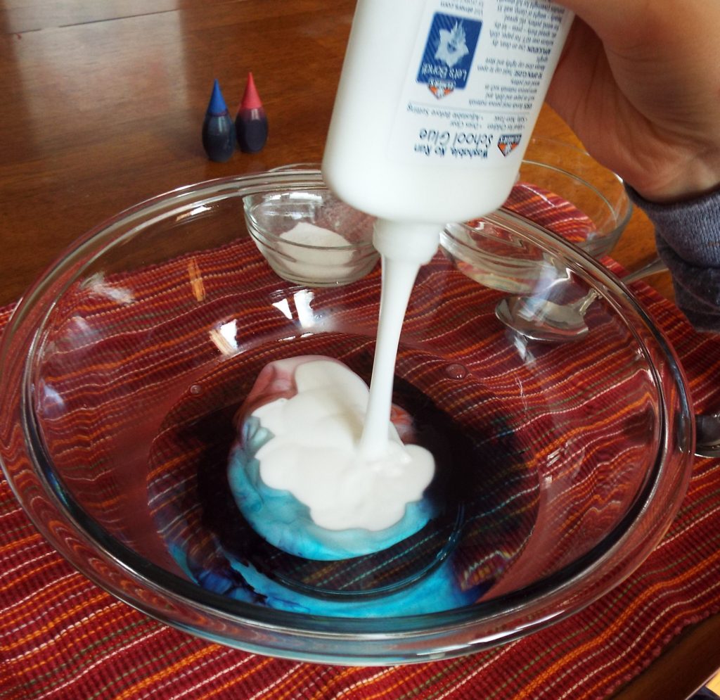 Pouring school glue into warm water.