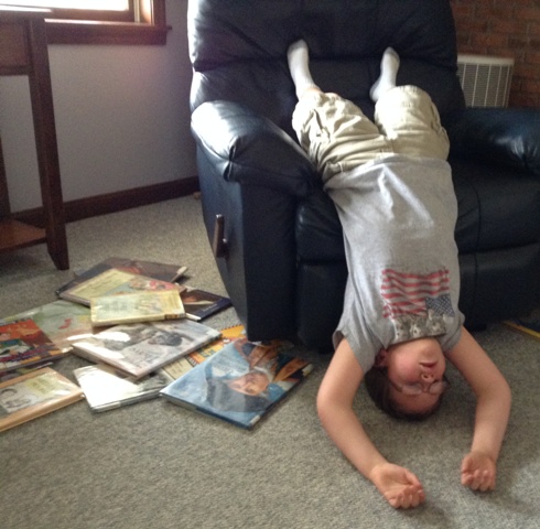 Learning to read can be exhausting! Andrew takes a break hanging out upside down. 