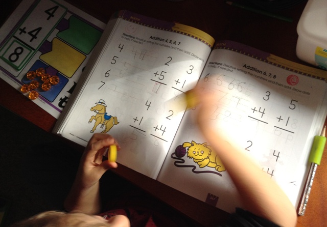 Boy working on addition problems.