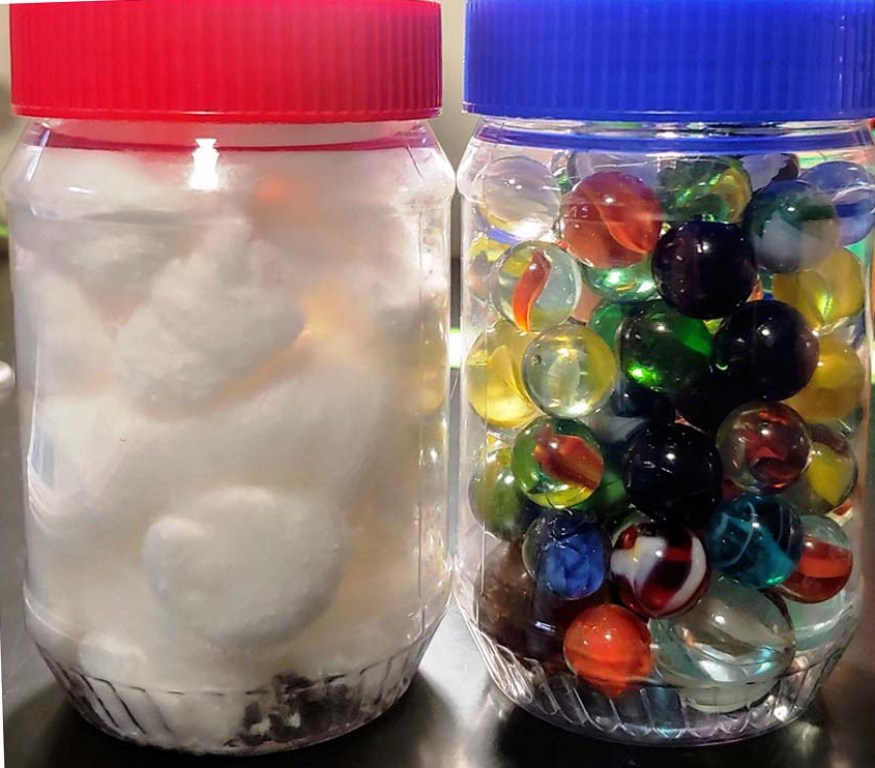 Jars full of marbles and cotton balls