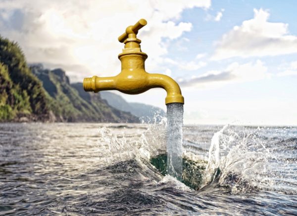 Running faucet over a large body of water.