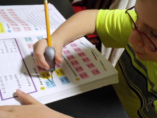 Child working in a math book